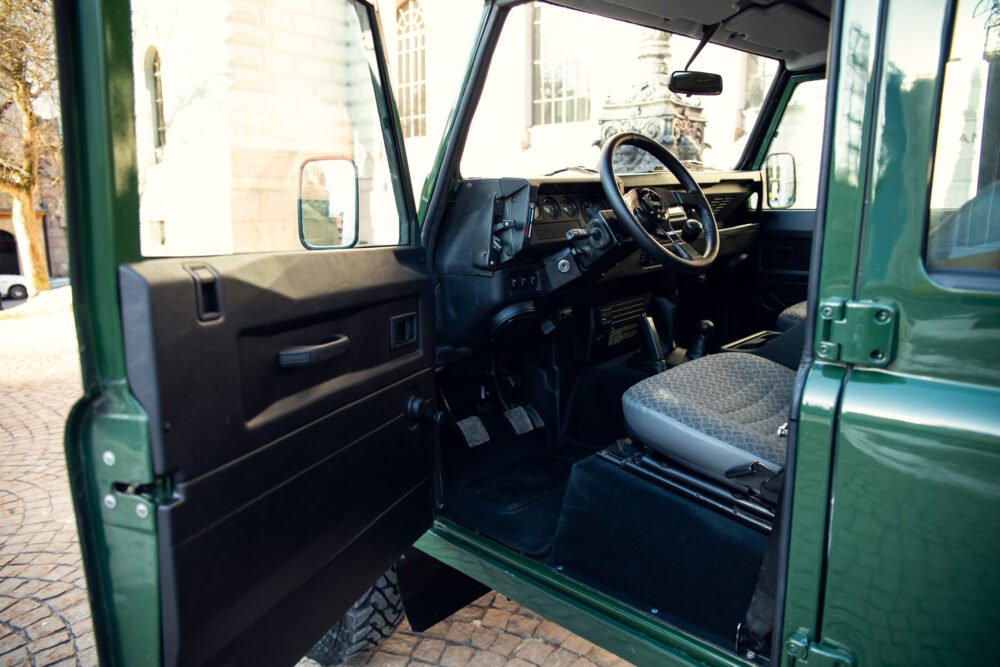 Green vintage SUV interior, open door view.