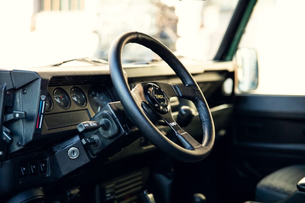 Close-up view of vehicle's steering wheel and dashboard.