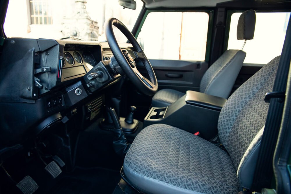 Interior view of a modern vehicle's driver's seat and dashboard.