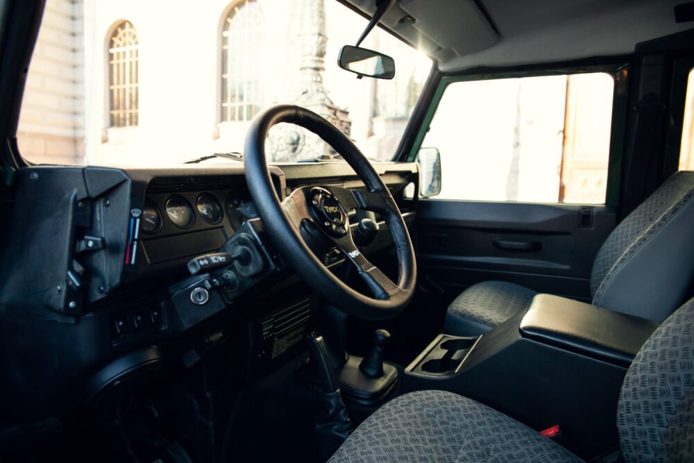 Interior of classic SUV with steering wheel and dashboard.