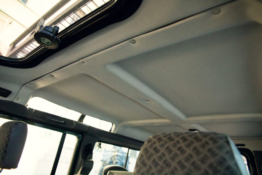 Interior of car showing ceiling and rear seats.