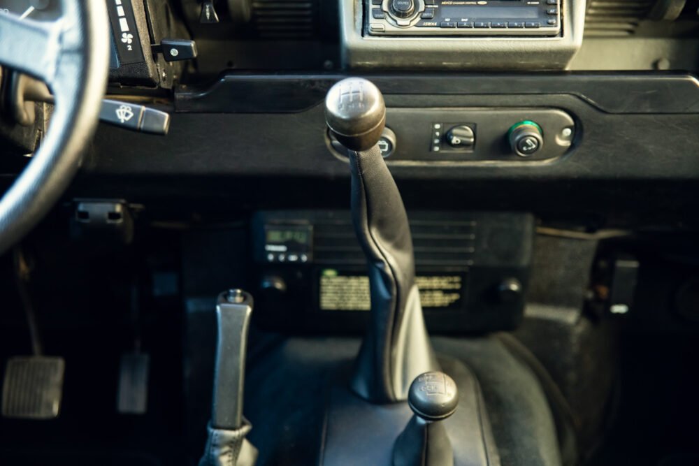 Classic car interior with manual transmission gear shift.