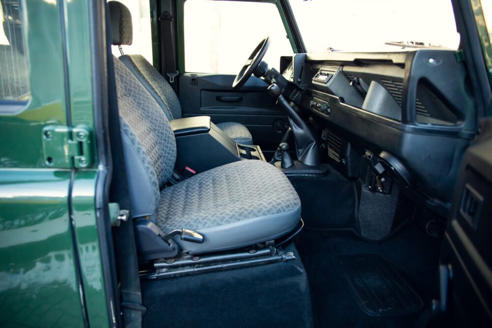 Interior view of classic green SUV with patterned seats.