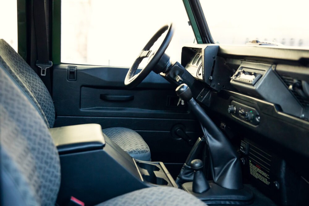 Interior view of vintage car dashboard and steering wheel.