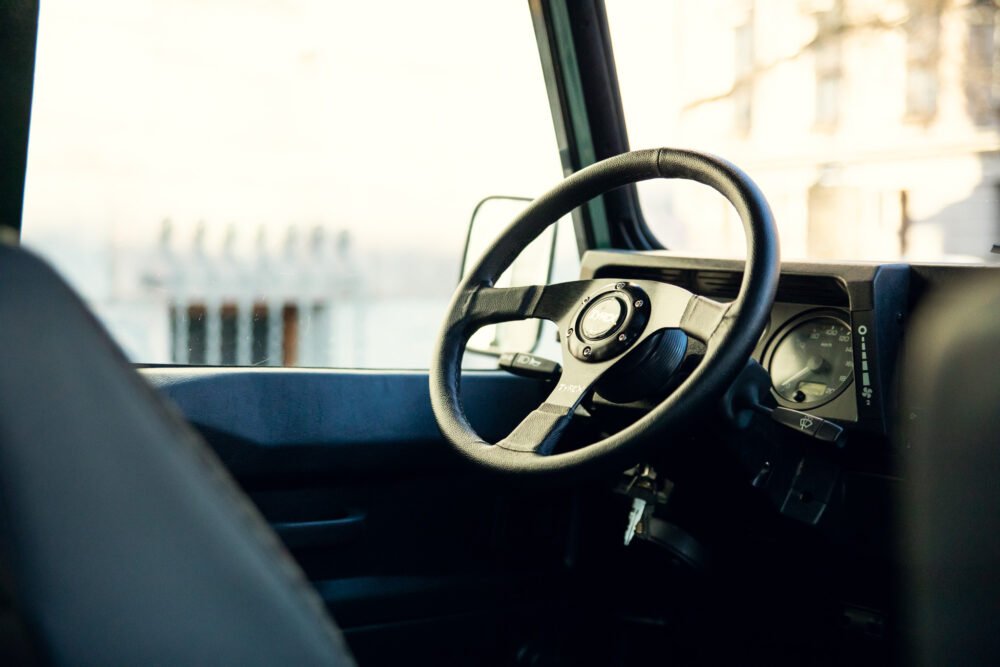 Interior of a modern vehicle focusing on steering wheel.