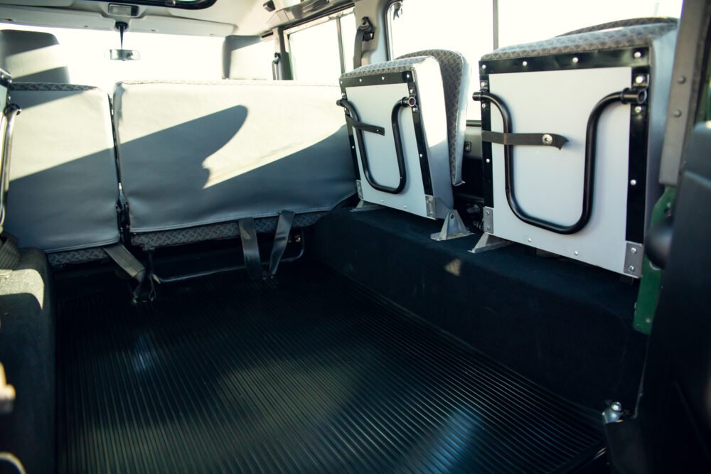 Interior view of empty bus seats and floor.