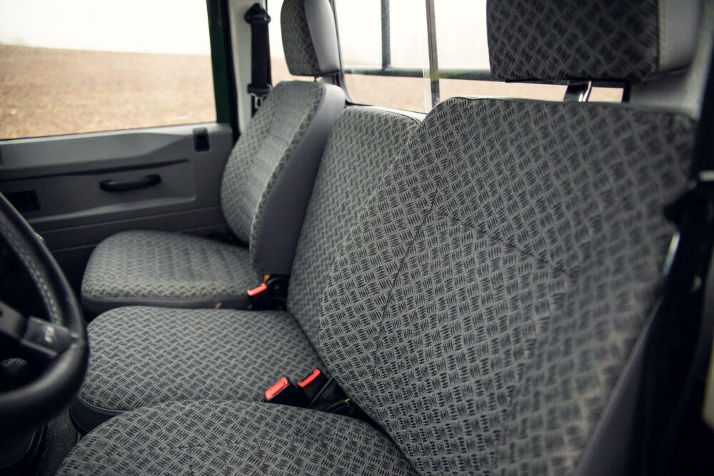 Interior view of a vehicle showing patterned fabric seats.