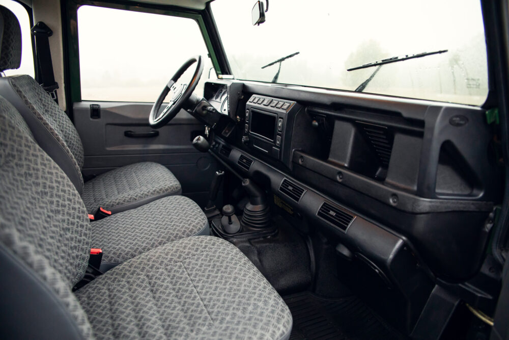 Interior view of vintage car with patterned seats.