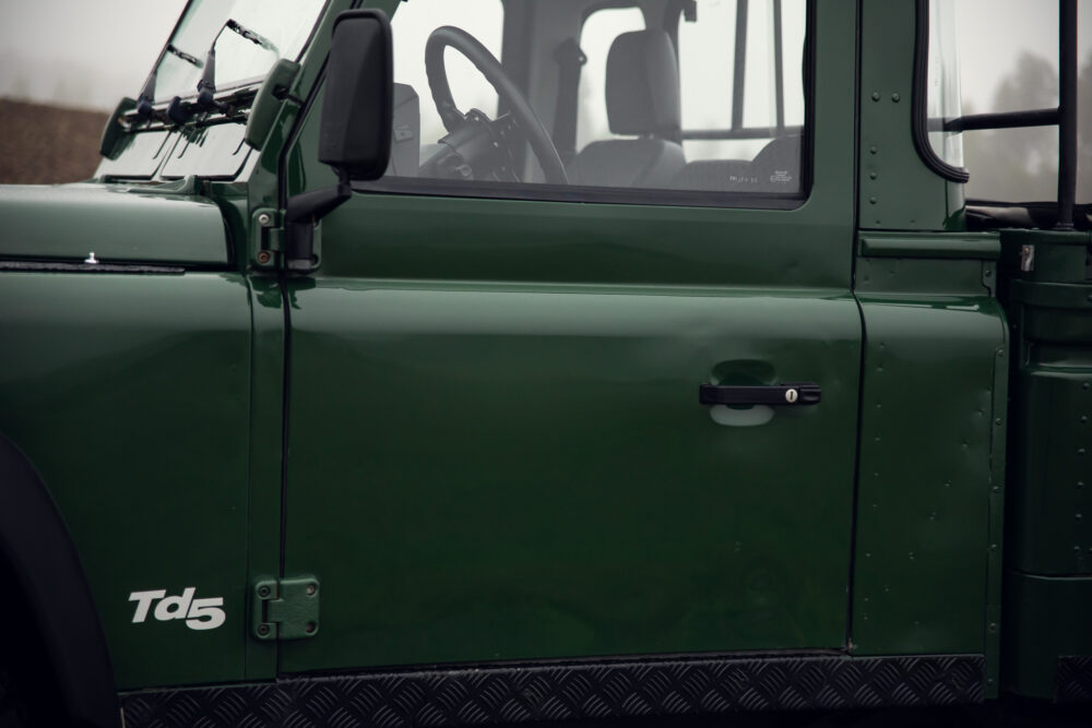 Close-up of green Land Rover Td5 door and window.