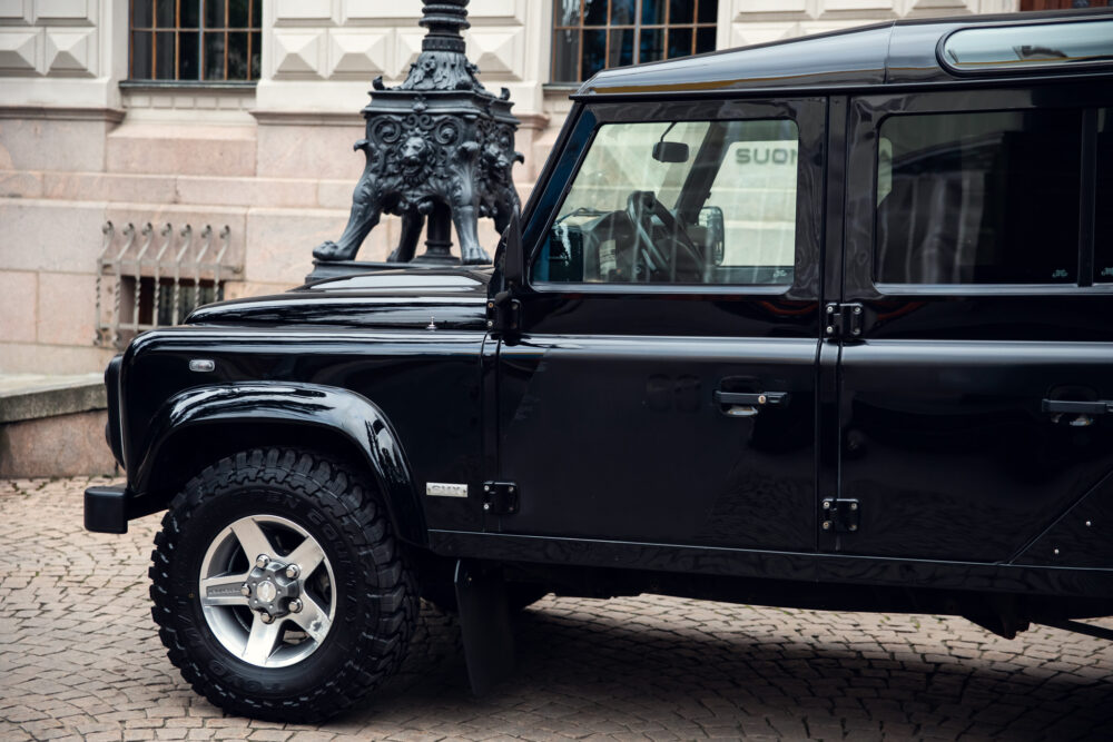 Black SUV parked near ornate lamp post.