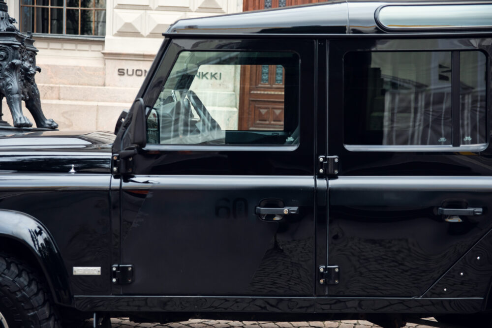 Black SUV parked near historic building.