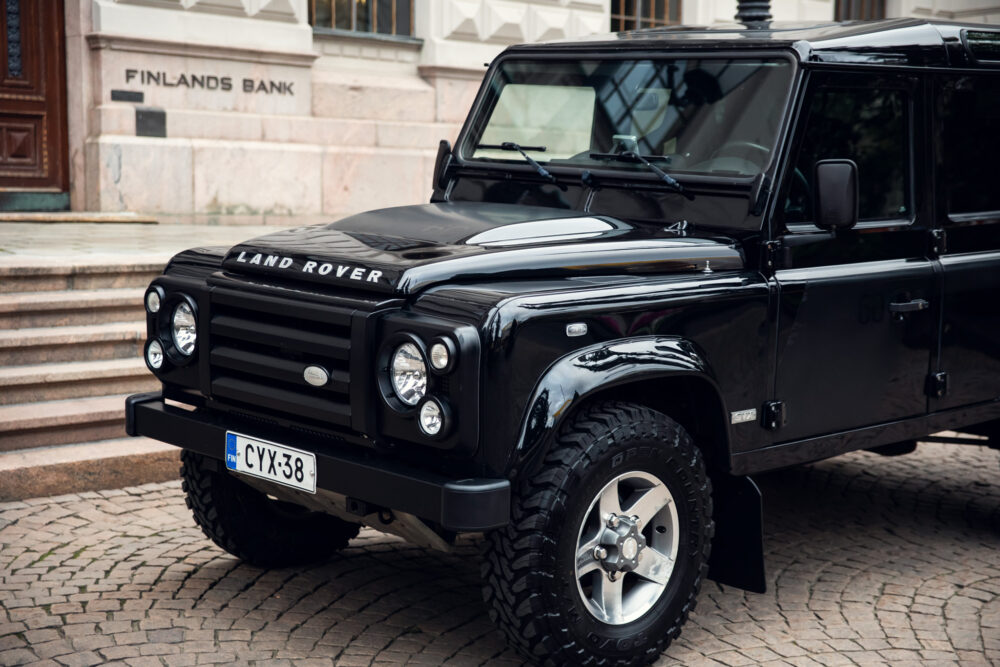 Black Land Rover parked in front of Finland's Bank.