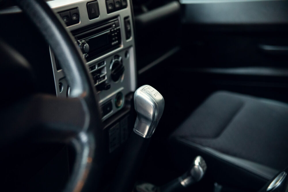 Car interior with steering wheel and gear shift.