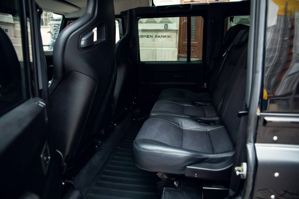 Interior view of a spacious, modern van with black seats.