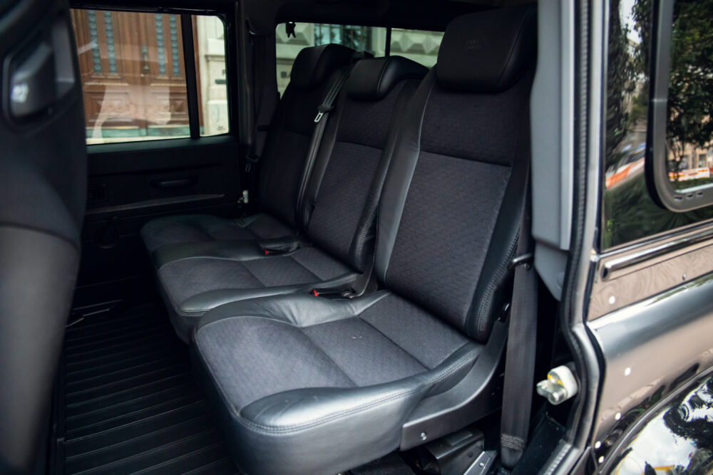 Interior view of a spacious modern vehicle with three seats.