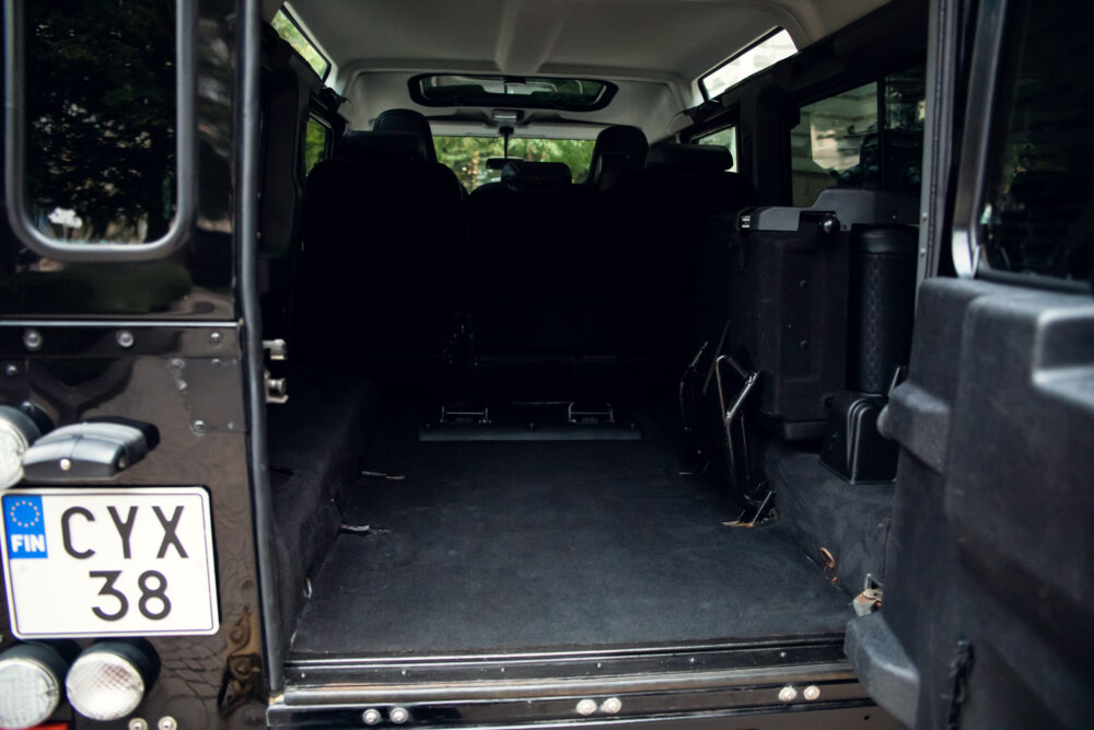 Empty cargo area of an SUV with Finnish license plate.