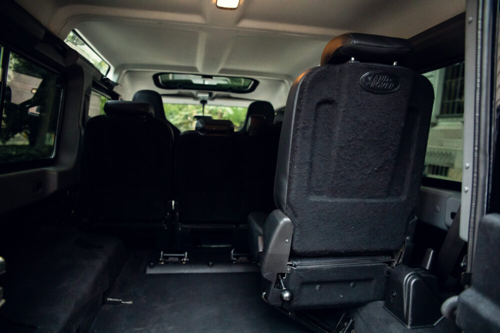 Interior of van showing multiple rows of seats.