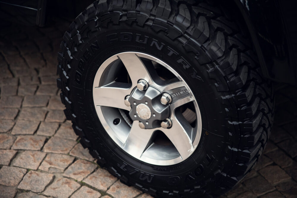 Rugged off-road tire on vehicle wheel.