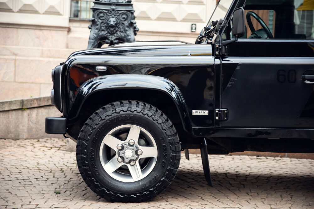 Black SUV parked, stylish wheel close-up.