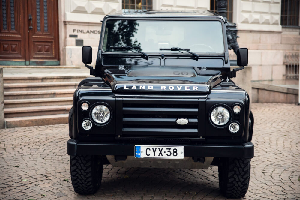 Black Land Rover parked in front of building.