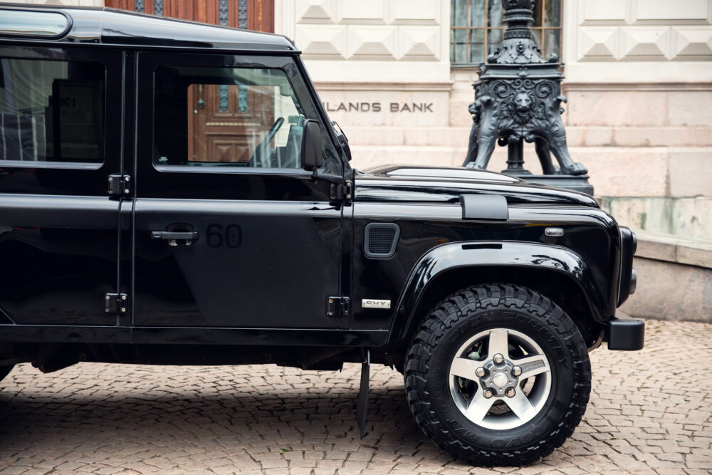 Black SUV parked near ornate historical building.