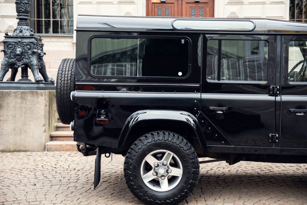 Black off-road SUV parked near ornate lamp post.