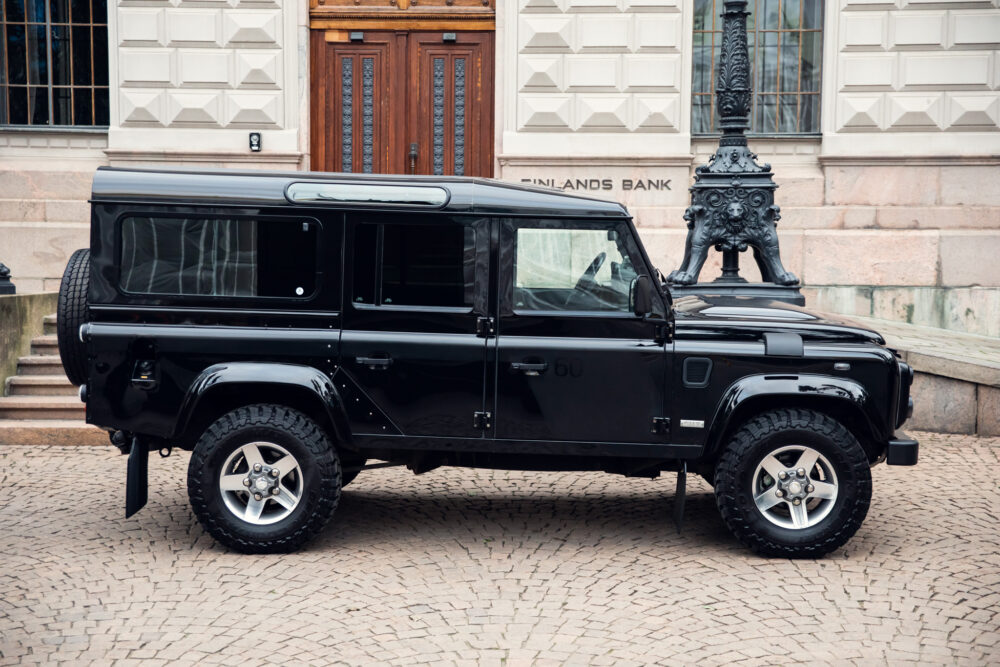 Black SUV parked in front of historic building.