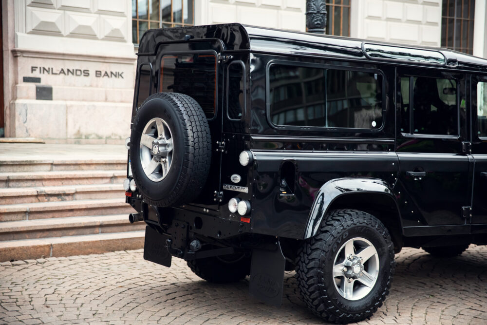 Black SUV parked outside Finland's Bank building.