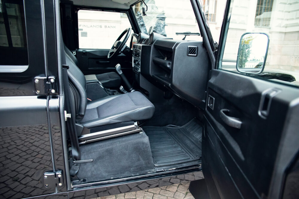 Open door view of modern SUV's clean, spacious interior.