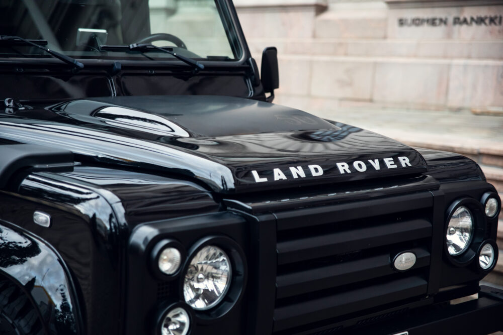 Close-up of black Land Rover hood and grille.