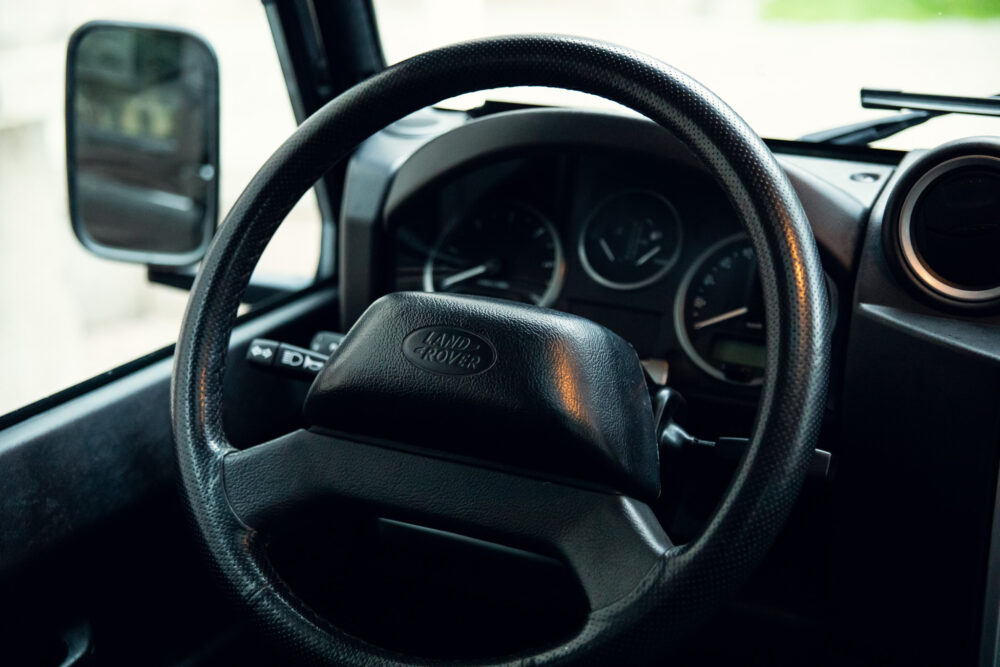 Land Rover steering wheel and dashboard close-up.