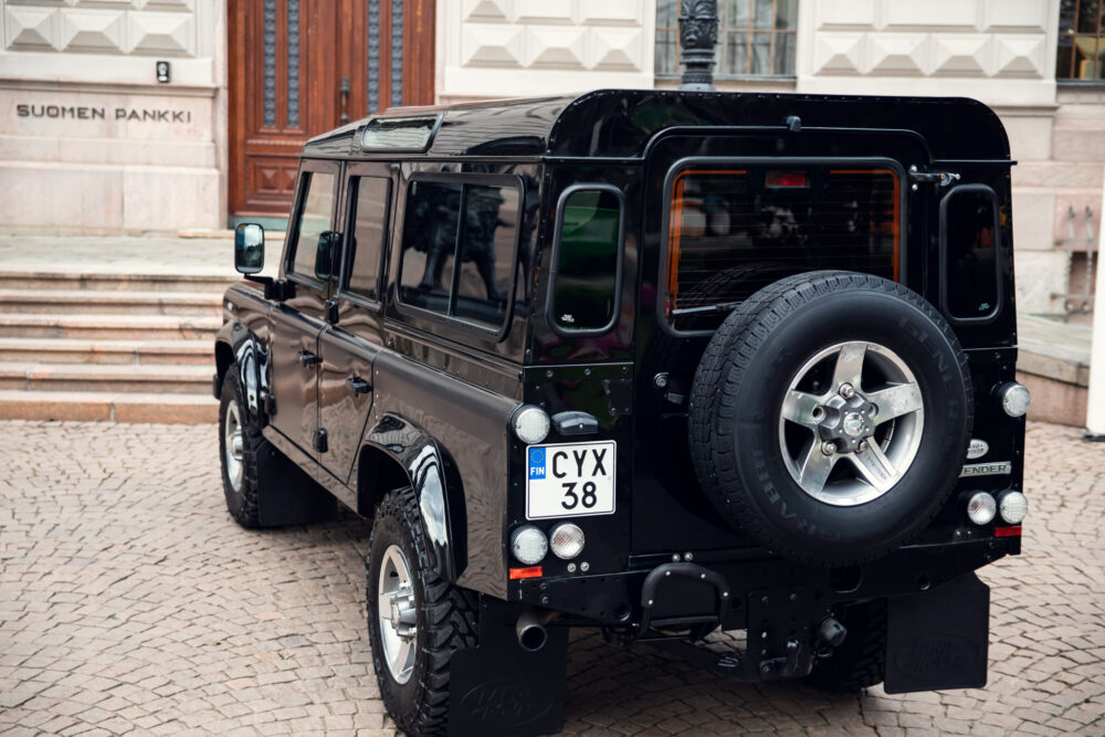 Black SUV parked near historic bank building.