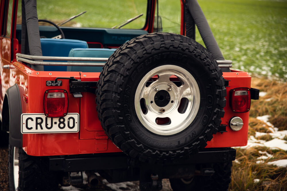 Red Jeep CJ7 rear view with spare tire