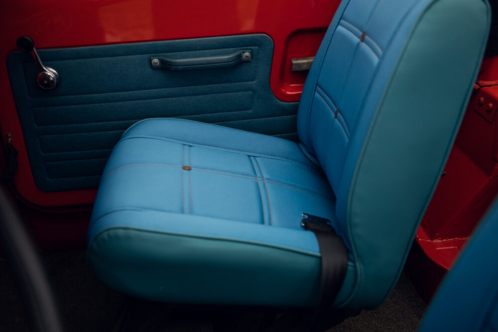 Blue vintage car seat with red door interior