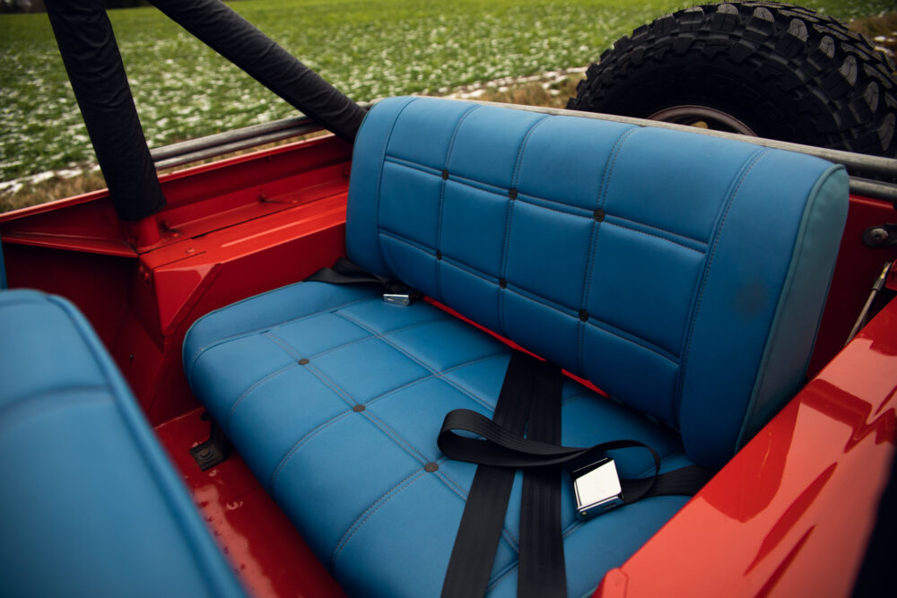 Blue seat in red vintage jeep with open top