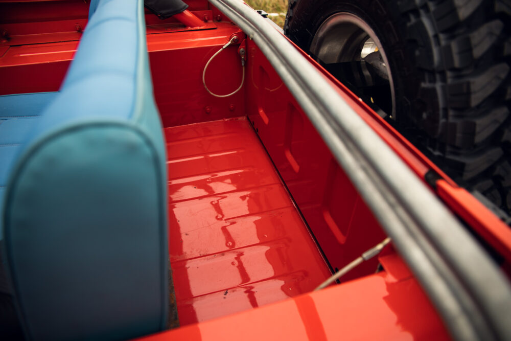 Red truck bed with blue seat and tire detail