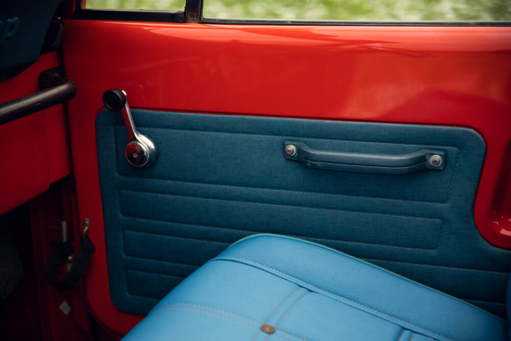 Vintage red car with blue upholstered door interior