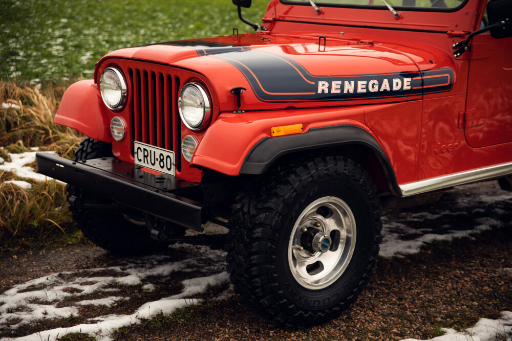 Red vintage Jeep Renegade on snowy ground