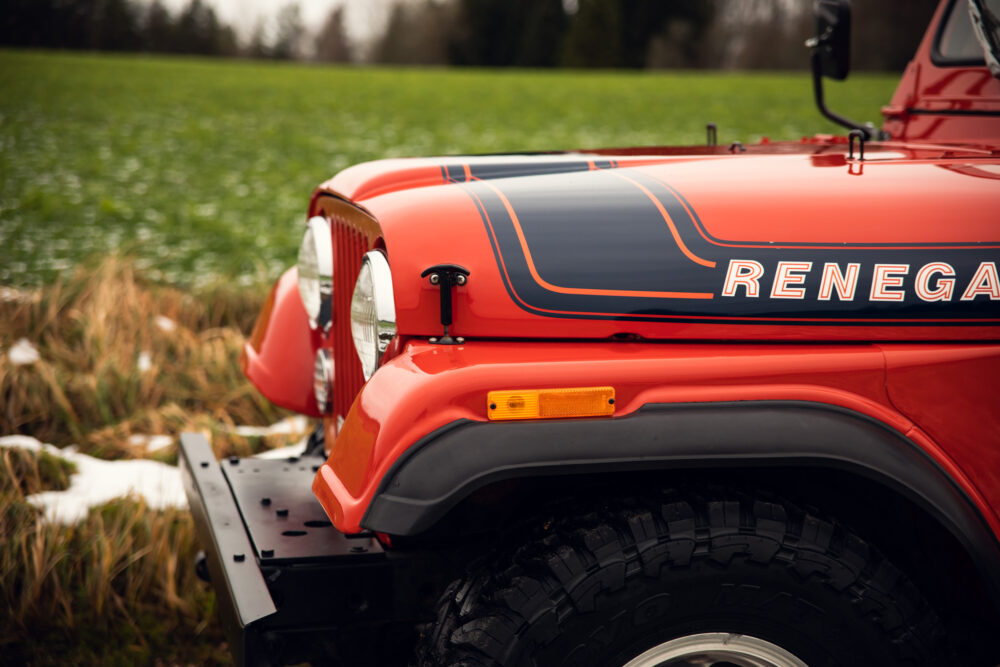 Red vintage off-road Jeep Renegade in field