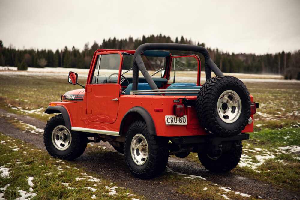 Red vintage off-road vehicle in snowy field