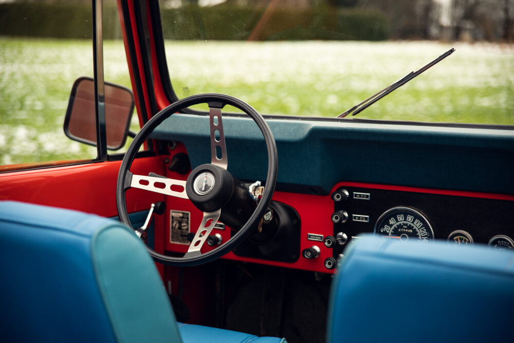 Vintage red car interior with steering wheel and dashboard