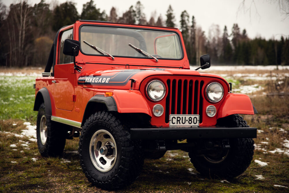 Red Jeep Renegade on snowy forest trail