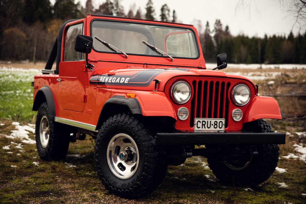 Red Jeep Renegade in snowy forest