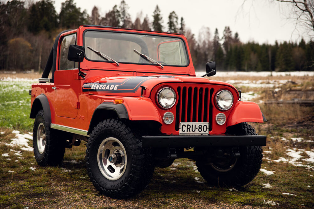 Red Jeep Renegade in snowy forest