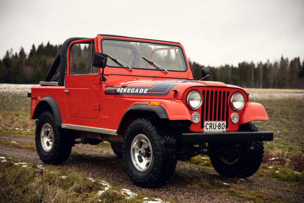 Vintage red Jeep Renegade in outdoor setting