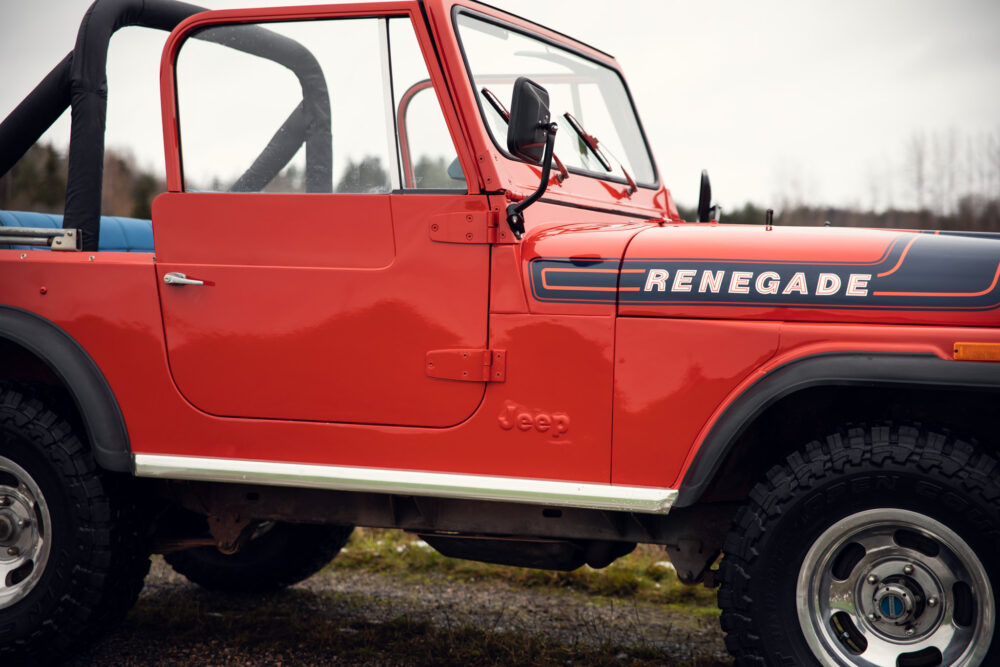 Red Jeep Renegade side view on overcast day