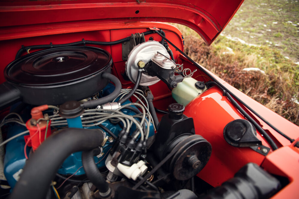 Detailed view of a vintage red car engine compartment