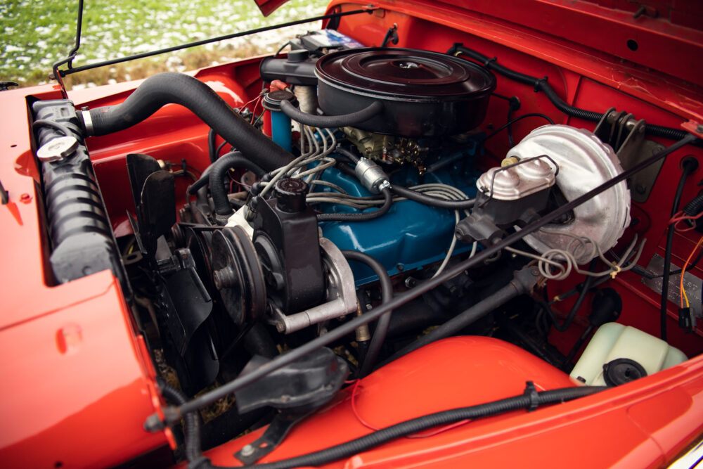 Detailed view of a classic car's red engine bay