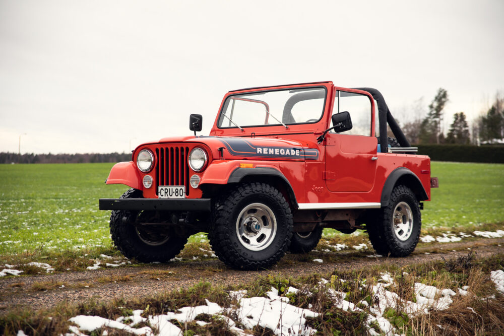 Red vintage Jeep Renegade on snowy field