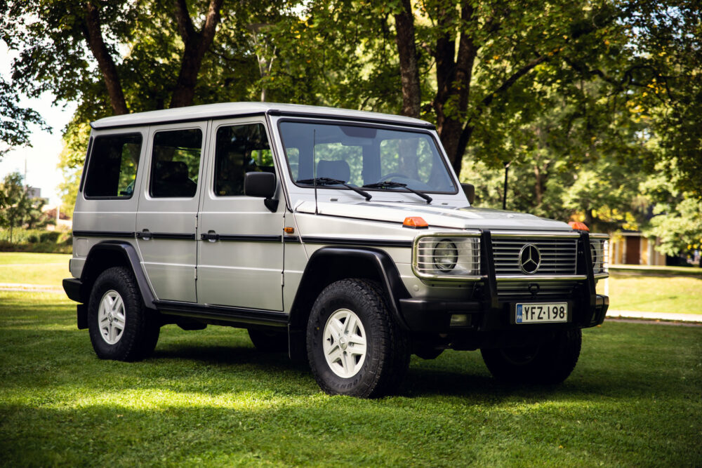 Silver Mercedes SUV parked on green grass